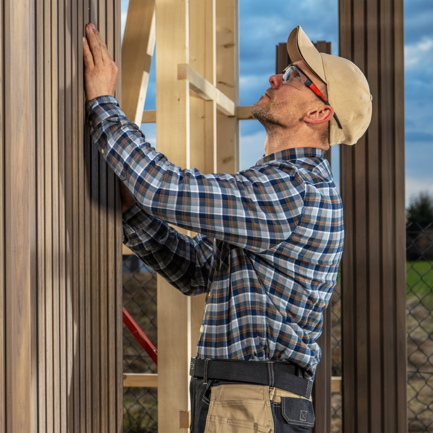 male working on siding